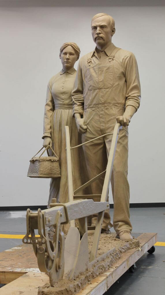 Picture of original clay sculpture of Farmer and Wife by Benjamin Victor.