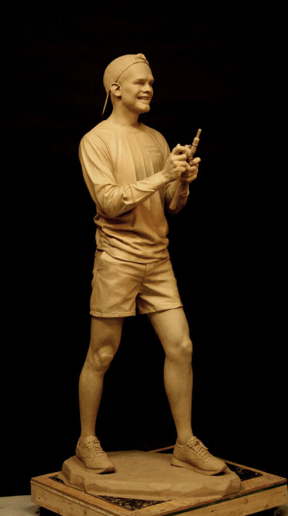 A sculpture of a young fisherman